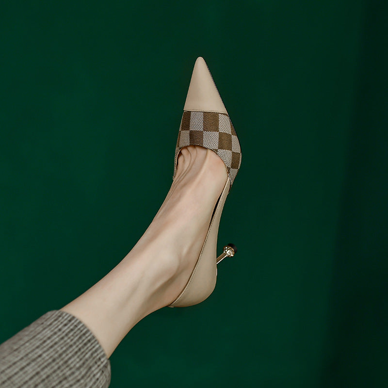 Beige high-heeled shoe with a checkered pattern on a dark green background